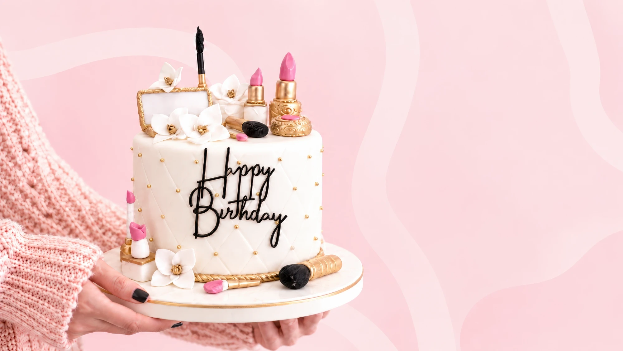 A handmade white birthday cake with gold and pink make-up details, held on a cake board